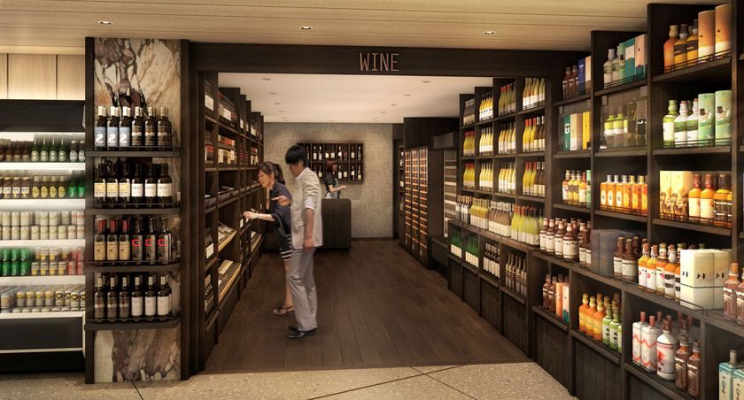 明治屋自由が丘ストアーのワイン売場。両側に酒瓶の棚が並び、通路の奥に人影
