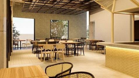プレスリリースで公開された店内の画像。明るい床に木のテーブルと椅子が並び、手前に籐の椅子、奥に大きなガラス窓がある